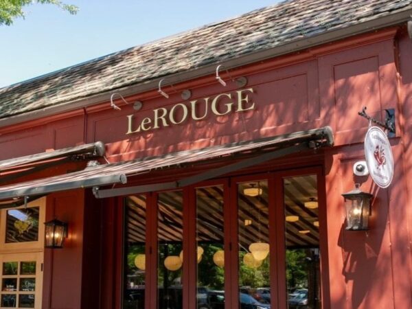 Exterior storefront and gold sign of Le Rouge Bakery.